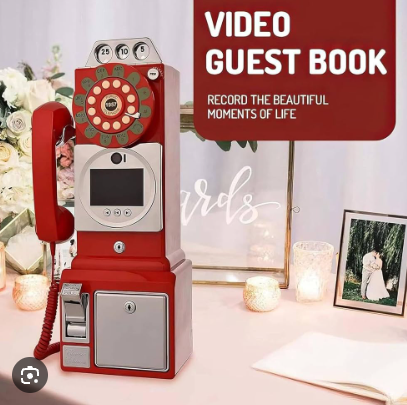 Red retro rotary phone video guest book set up on a wedding reception table